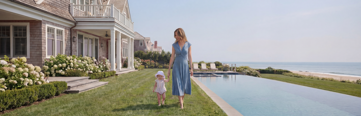 Mother walking with her child outdoors wearing a modern postpartum nursing dress, designed for everyday motherhood.
